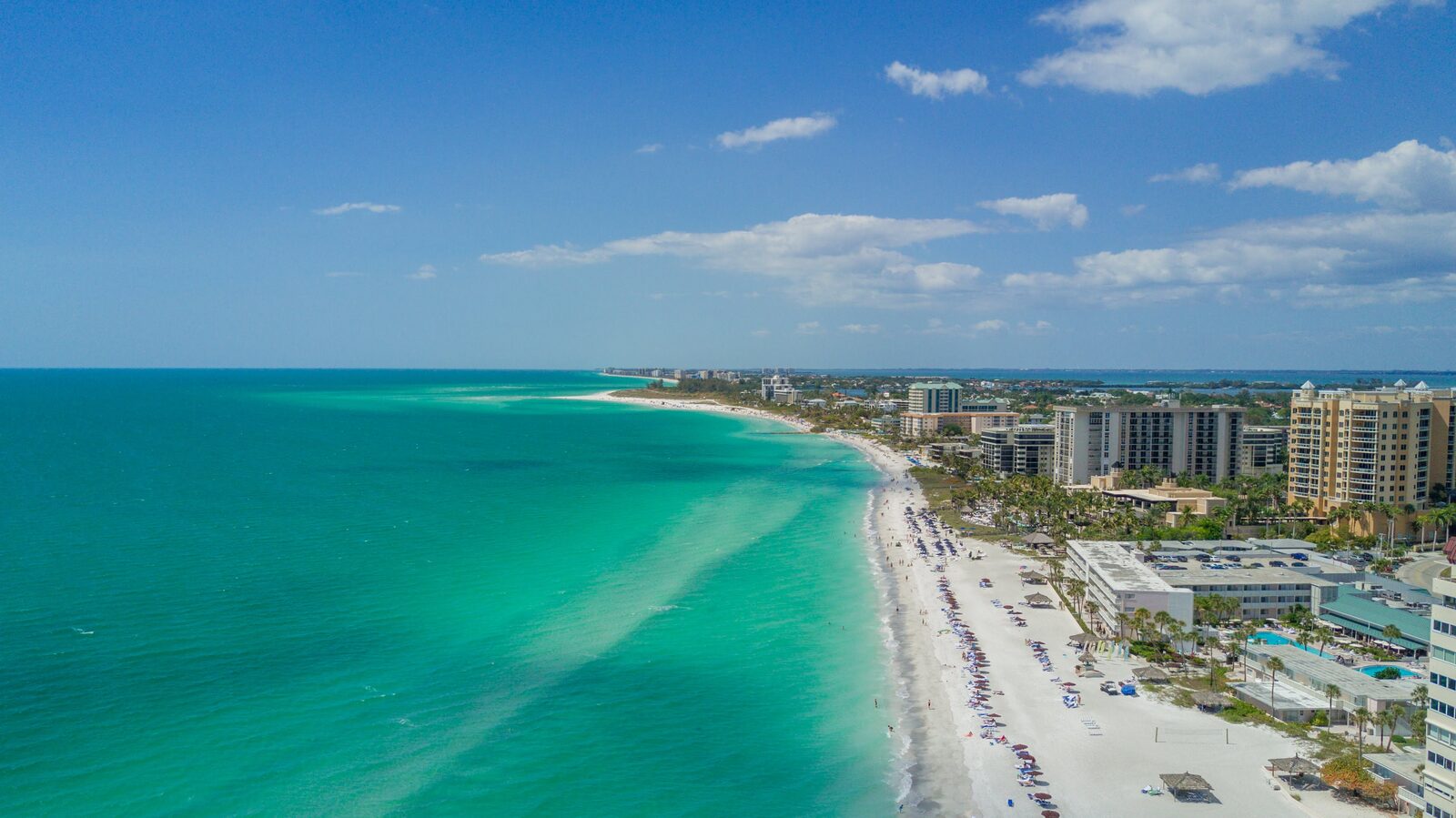 Aerial of the turquoise Gulf water and white sand of the Sarasota coast